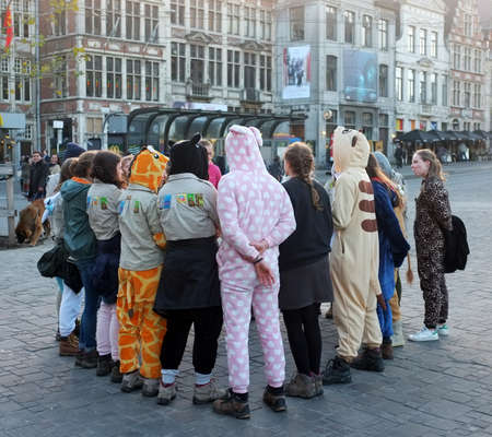Teenage workers in costumes gather on the street of Ghent .のeditorial素材