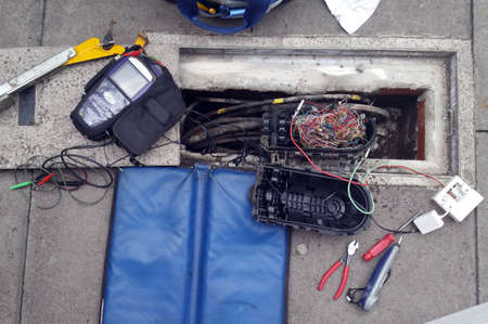Phone cables and tools during the repair on the pavementsの写真素材