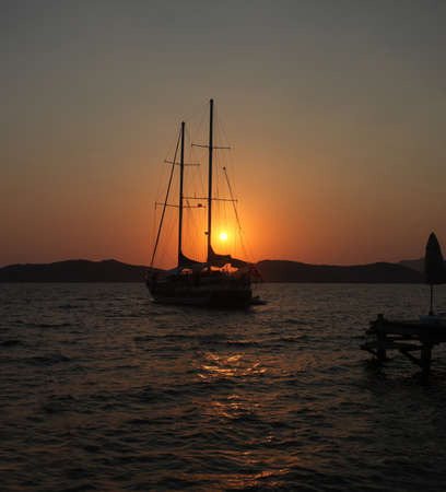 Yacht and jetty silhouettes at dawn in Marmaris, Turkeyの写真素材