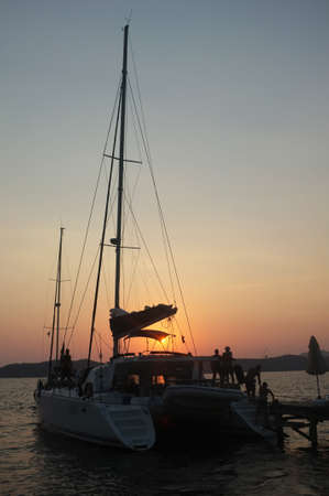 Yacht and jetty silhouettes at dawn in Marmaris, Turkeyの写真素材
