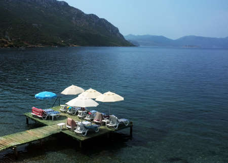 Jetty with parasols and beds on water in Marmaris, Turkeyの写真素材