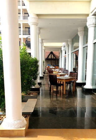 Outdoor dinning area with wooden arbor of a indian resort. Goa, Indiaのeditorial素材