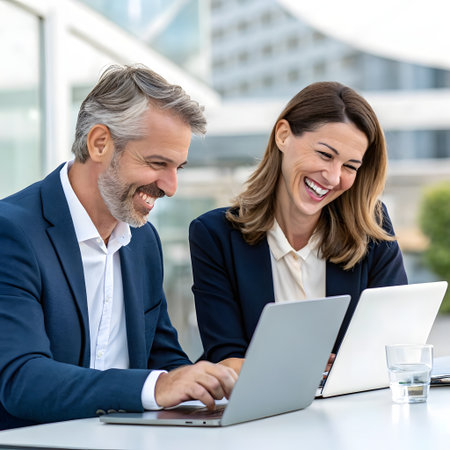 Businessman and businesswoman working together on a laptop in an officeの素材