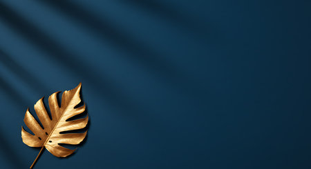 Golden monstera leaf on blue background with shadow. 3D renderingの素材