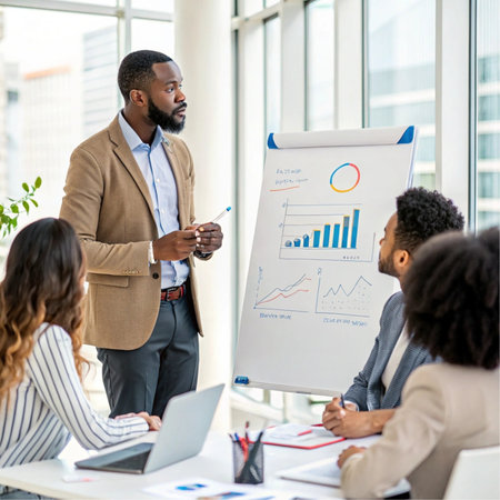 african american businessman pointing at flipchart during meeting in officeの素材