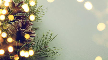 Christmas and New Year background with bokeh lights and pine conesの素材