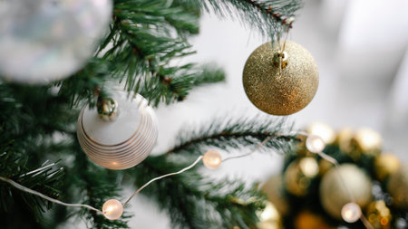 Christmas tree decorated with baubles and garlands on blurred backgroundの素材