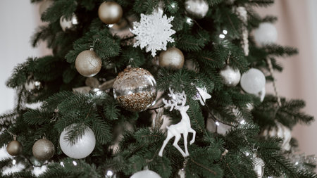 Decorated christmas tree with silver and gold baublesの素材