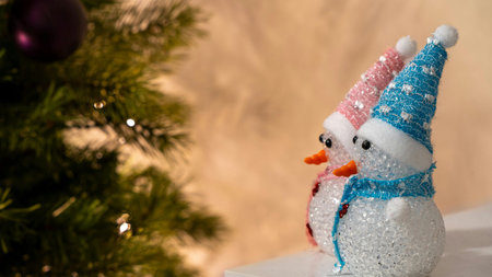 Snowman and Christmas tree on a white background with bokehの素材