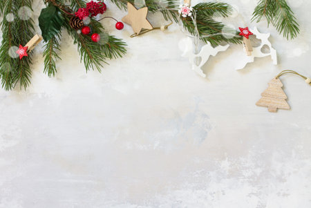 Christmas background with fir tree branches, toys and decorations on light backgroundの素材