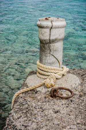 Old howser on the concrete mooring post in a portの写真素材