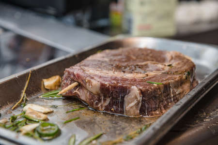 Raw Marbled Meat of Ribeye Steak with Herbs before roastingの写真素材