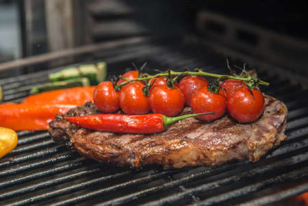 Club Steak and Grilled Vegetables Being Prepared in Josper Grillの写真素材