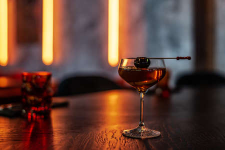 Coctail with Black Olive on the Stick on the Tableの写真素材