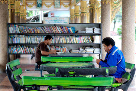BANGKOK, THAILAND - AUGUST 1   Unidentified men reading a book at Wat Lanboon Temple  Temple is the...