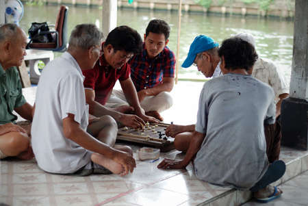 BANGKOK, THAILAND - AUGUST 1   Unidentified men play Thai Chess at Wat Lanboon Temple  The game is  popular in thailand called Makruk  in Bangkok, Thailand on AUGUST 1 2013のeditorial素材