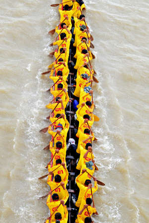 BANGKOK, THAILAND-AUG 25  Unidentified crew in traditional Thai long boats compete during King s Cup...