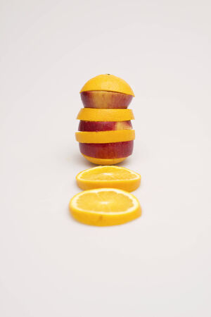 Apple and orange stacked togetherの写真素材