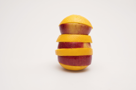 Apple and orange stacked togetherの写真素材