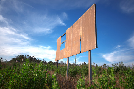 Outback rusted blank damaged and old sign in the long grass.の写真素材