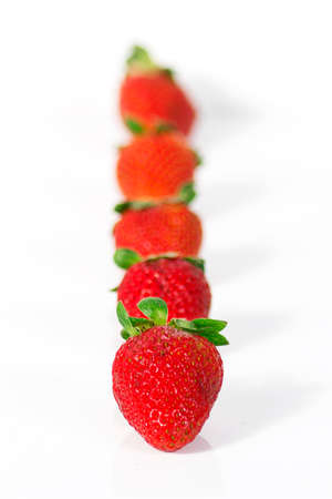 A group of fresh strawberries isolated on a white background.の写真素材