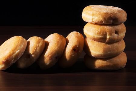 Group of fresh baked cinnamon donuts with raspberry jam.の写真素材