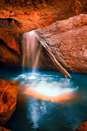Waterfall with orange and red colours in the Gold Coast hinterlands on the Queensland and New South Wales border.の写真素材
