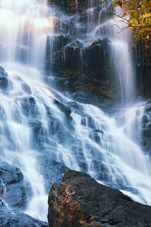 Waterfall with orange and red colours in the Gold Coast hinterlands on the Queensland and New South...