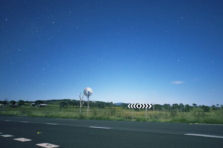 Windmill with stars in the background in the outback of Queensland, Australia. High Noise.の写真素材