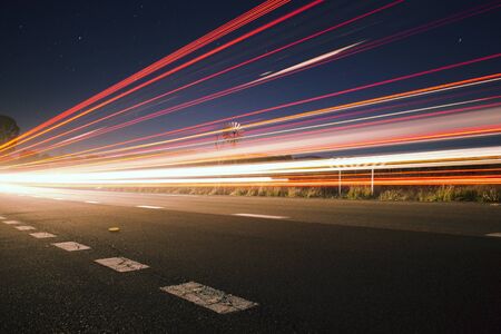 Light trails at night with stars in the outback of Brisbaneの写真素材