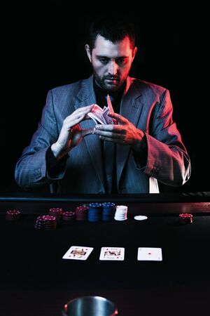 Concept: A high stakes poker player is frustrated and emotional over loosing and finding it hard to contain his emotions. Cinematic portrait.の写真素材