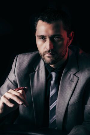 Concept: A high stakes poker player is frustrated and emotional over loosing and finding it hard to contain his emotions. Cinematic portrait.の写真素材