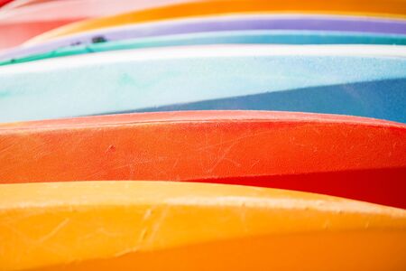 Row of colorful kayaks at sea shore on Tangalooma Island, Queensland.