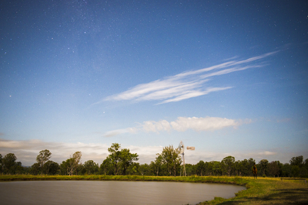 Windmill at night with shining stars in the countryside near Mount Walker, Queensland, Australia.の写真素材