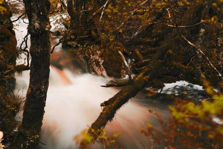 Knyvet Falls in Cradle Mountain, Tasmania after heavy rainfall with abstract red hues added.