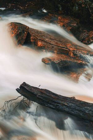 Knyvet Falls in Cradle Mountain, Tasmania after heavy rainfall with abstract red hues added.の写真素材