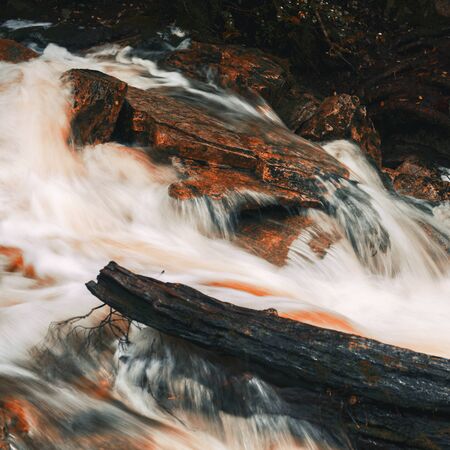 Knyvet Falls in Cradle Mountain, Tasmania after heavy rainfall with abstract red hues added.の写真素材