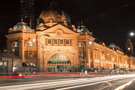 Flinders street railway station in central Melbourne city, Australia at night with trafficのeditorial素材