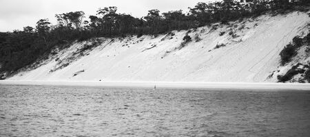 View of the pristine beachfront at North Point, Moreton Island during the day. Black and White.の写真素材