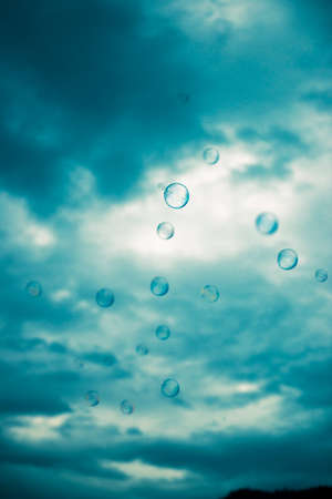 Bubbles floating in the outside amongst a country field.
