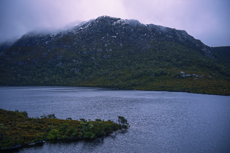 View of a cradle mountain in Tasmania, Australia on a cloudy day.の写真素材