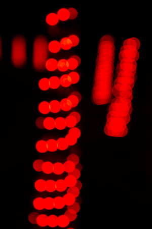 Colourful Christmas themed bokeh with a dark backgroundの写真素材