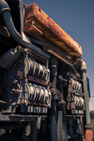 Rusted old fuel pump at the front of an abandoned fuel station.の写真素材