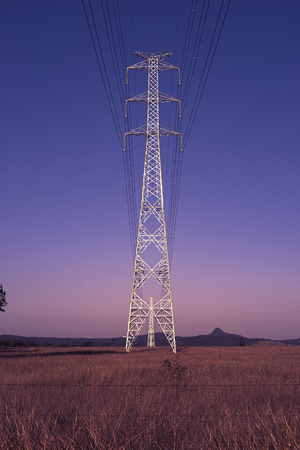 High voltage power tower at night with stars in the background in Brisbane, Queensland.
