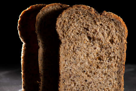 Detailed close up of high fibre low GI seven seeds and grain bread in low key lighting