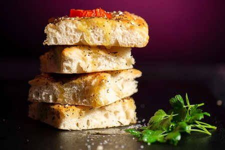 Fresh baked focaccia with cherry tomato, poppy and sesame seeds, pepper, Himalayan rock salt and...