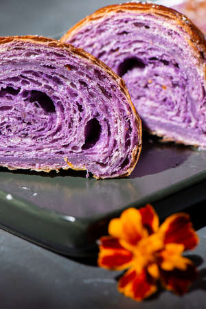 Fresh baked home made Ube Croissants using flavouring and purple yam powder and three book folds, lightly sprinkled with coconut.の写真素材