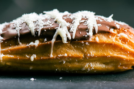 Home-made Eclair with mango and coconut whipped cream. Dipped in milk chocolate.