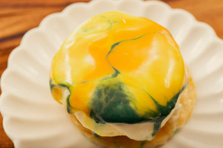 Delicious mango entremet with coloured glaze, sponge cake, mousse and jelly.の写真素材