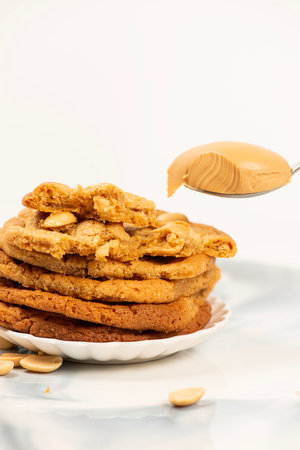 Pile of oatmeal cookies with peanut butter on a white background